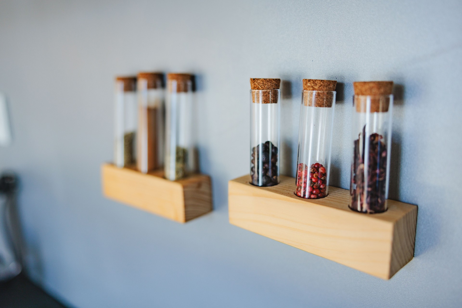 Wooden Shelves Holding Some Glass Tubes With Some Spices Inside